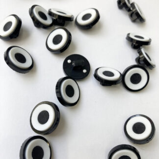White with Black centre 'target', and rim moulded Plastic button on shank